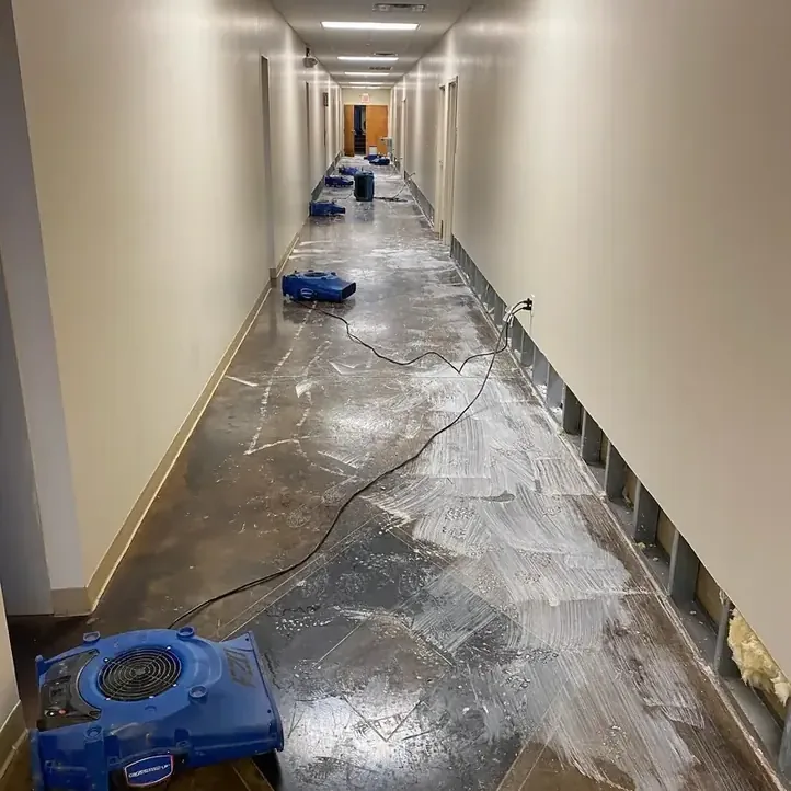 Narrow hallway with walls cut low and drying equipment placed along the floor