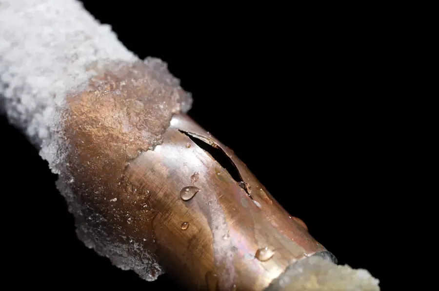 Water pipe split open by a hard freeze inside a home